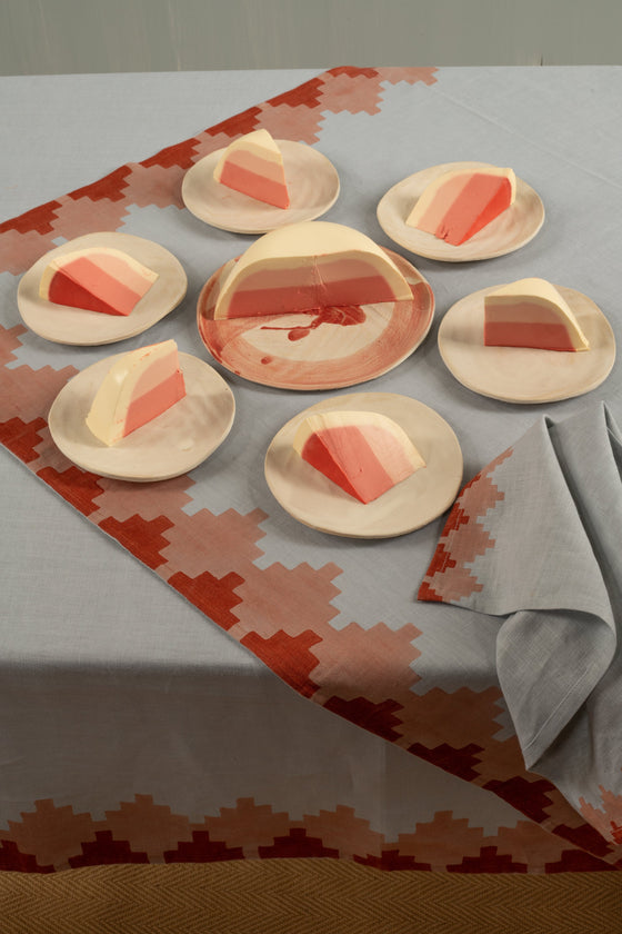 Blue napkin with red trim next to plates of dessert