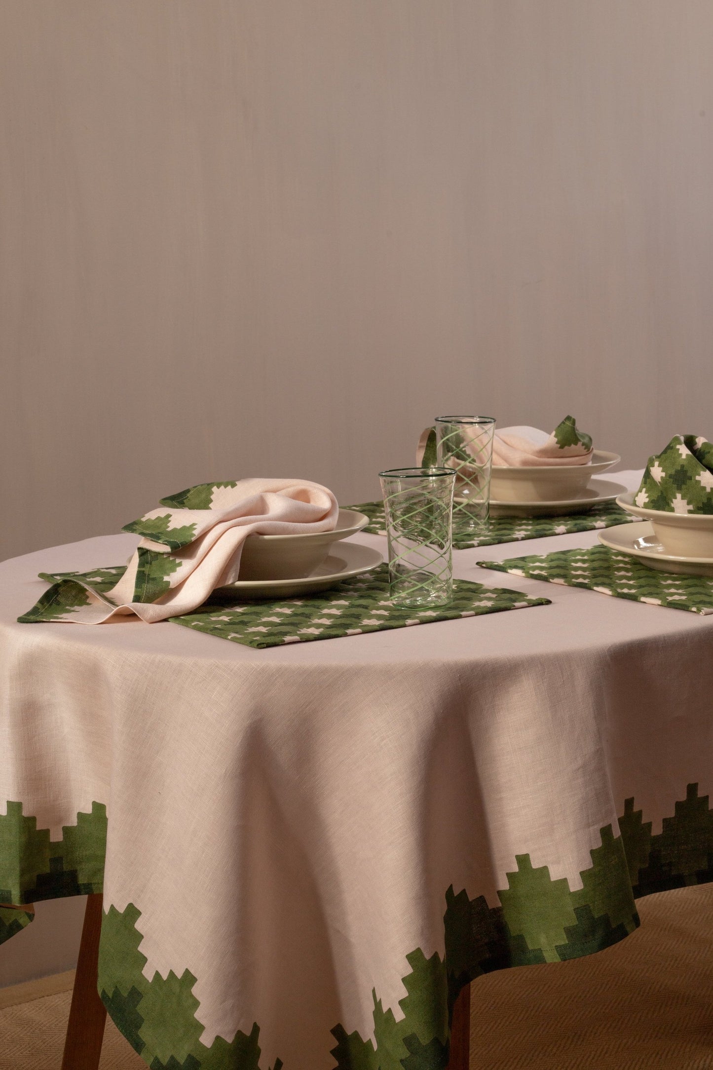 Three place settings with pink and green placemats