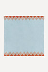 Blue napkin with red trim on two opposite edges
