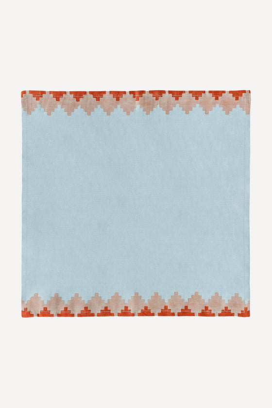 Blue napkin with red trim on two opposite edges