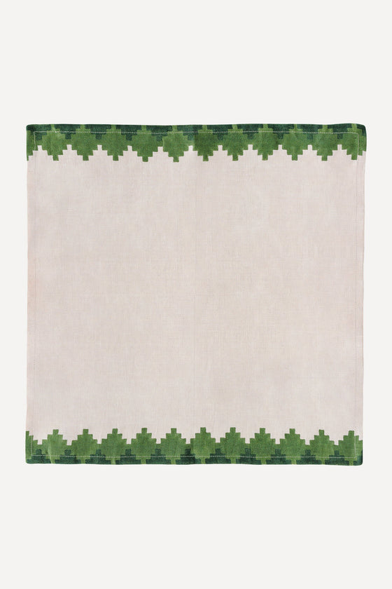 Pink napkin with green trim on two opposite edges