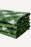 Stack of four folded pink and green napkins